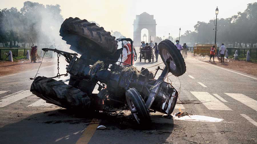 A tractor that was set on fire near India Gate during a protest in New Delhi on Monday against the new farm laws.