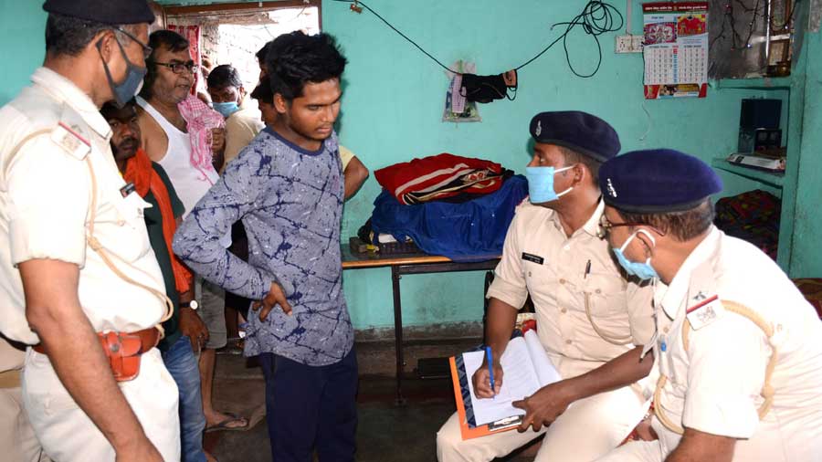 Policemen investigate the murder of the woman in Dhanbad on Tuesday.
