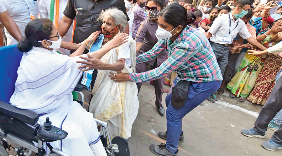 Mamata Banerjee greets an elderly supporter during a padayatra in Howrah on Saturday.
