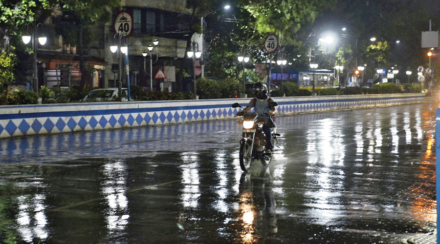 A motorcyclist amid rain near Sovabazar Metro station on Sunday night. 