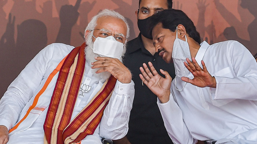 Prime Minister Narendra Modi with BJP candidate Rajib Banerjee during an election campaign rally for State Assembly polls, at Dumujola Stadium in Howrah district on Tuesday.