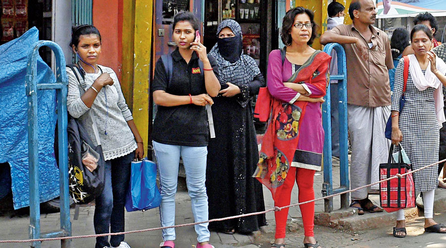 People neither wearing masks, nor maintaining social distancing