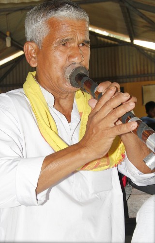 A member of the community plays the mukha banshi  