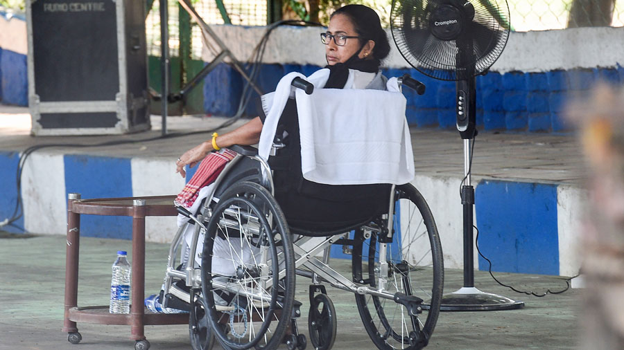 Bengal Chief Minister Mamata Banerjee, sitting on a wheel-chair, stages a protest in front of the Gandhi Statue in Calcutta on Tuesday.