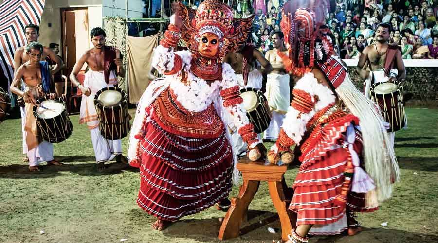 Theyyam inside a temple complex in a village near Kannur, Kerala