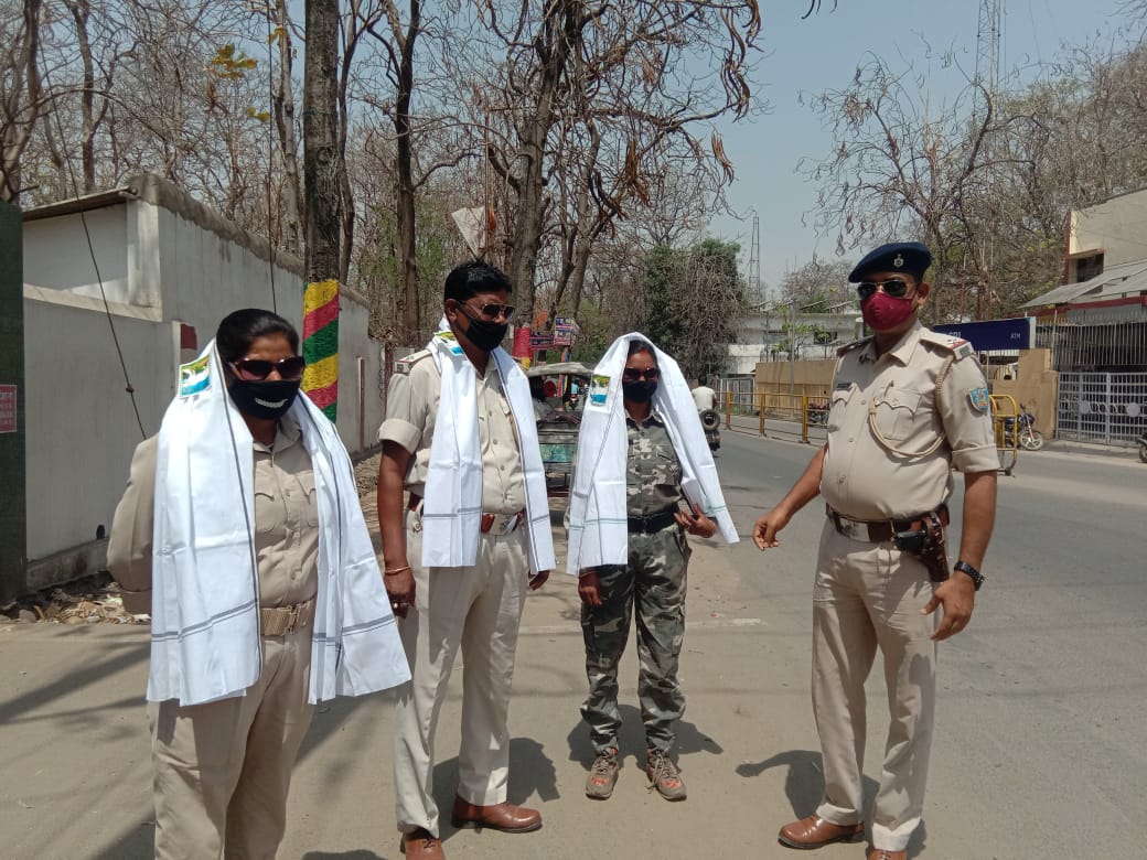 Traffic police officials in Daltonganj use towels and sunglasses provided to them on Wednesday.