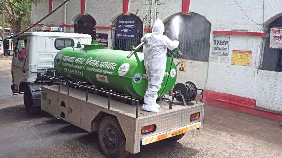 A worker sprays sodium hypochlorite solution from a tanker during the sanitisation drive in Dhanbad on Thursday.