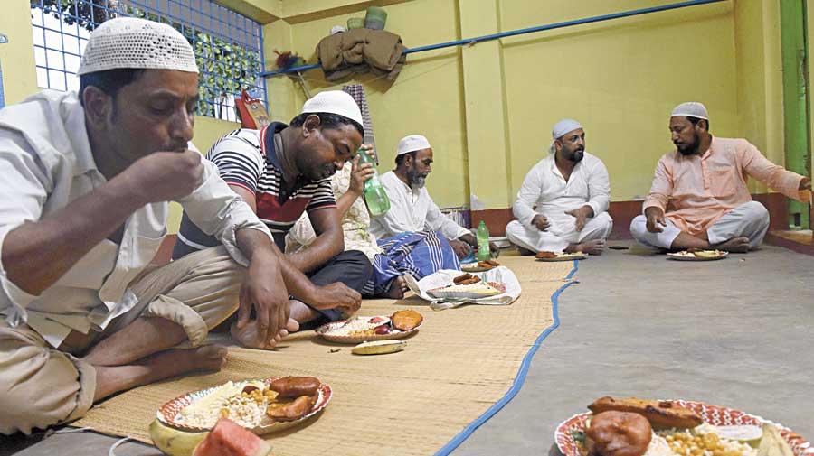 The Thursday iftar at the mosque.  Partha Sarathi Basu (second from right) eats with others. 