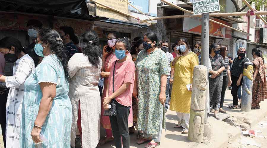 People queue up outside Don Bosco Splendid Home polling station at Bangur Avenue without maintaing social distance on Saturday