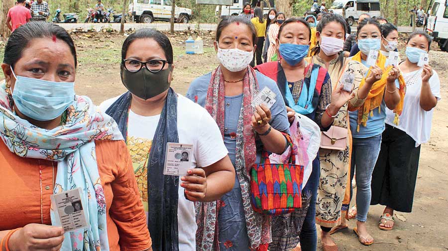 Women show their voter I-cards at a polling booth in Sukna, on Siliguri outskirts, on Saturday. As many as 45 Assembly seats across Darjeeling, Jalpaiguri, Kalimpong, Nadia, North 24-Parganas and East Burdwan voted in the fifth phase of Bengal polls that were largely peaceful with sporadic clashes. The electoral fate of leaders such as Gautam Deb and Bratya Basu of Trinamul, Asok Bhattacharya of the CPM and Samik Bhattacharya of the BJP were sealed on Saturday. 