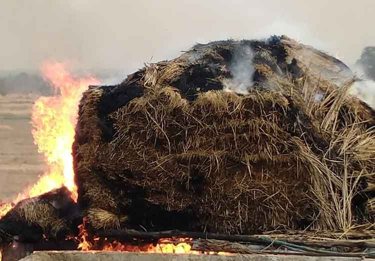 The stack of hay on fire