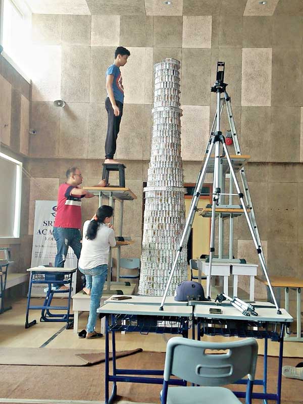 As the structure becomes taller, his mother and uncle help him build it
