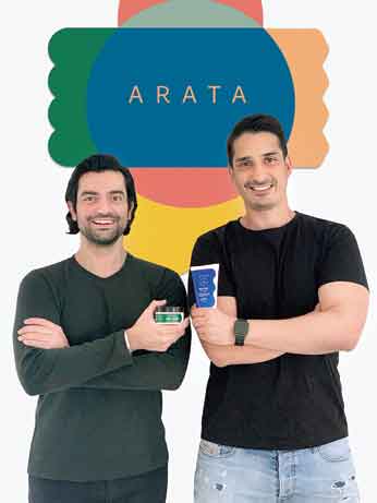 Dhruv Madhok and Dhruv Bhasin (right) pose with Arata products