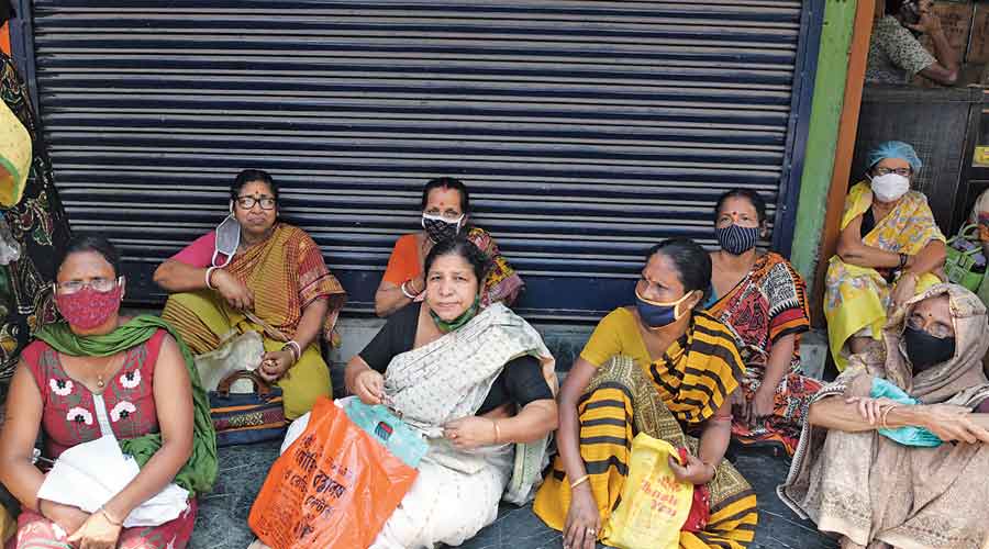 Recipients wait for their Covid-19 vaccine dose outside a health centre in Kasba on Wednesday.