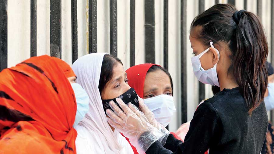 Relatives of a Covid-19 victim grieve  outside the mortuary of a Delhi hospital  on April 21. 