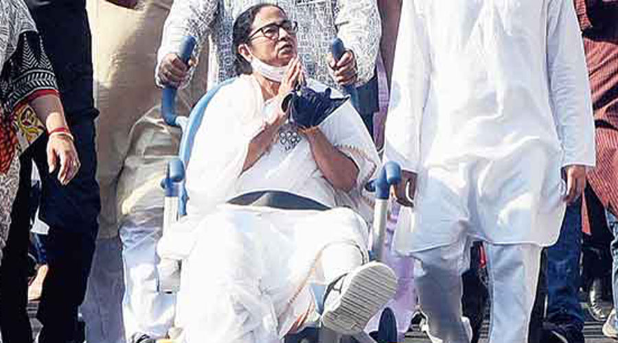 Chief minister Mamata Banerjee, seated in a wheelchair, leads a rally in Calcutta.