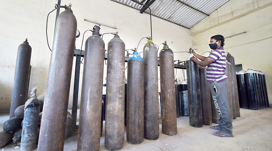 A worker sorts cylinders with medical oxygen in New Delhi on Sunday.
