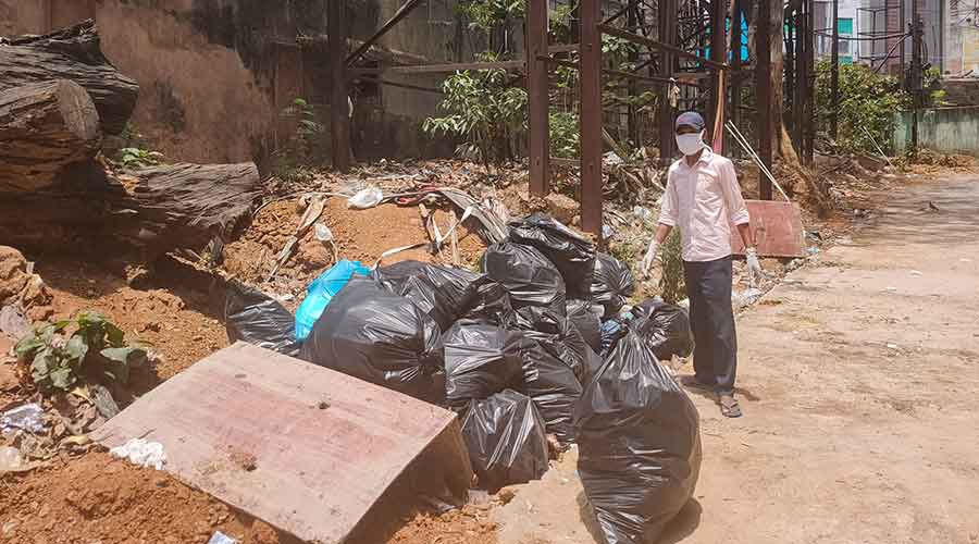 A hospital worker carrying medical waste.