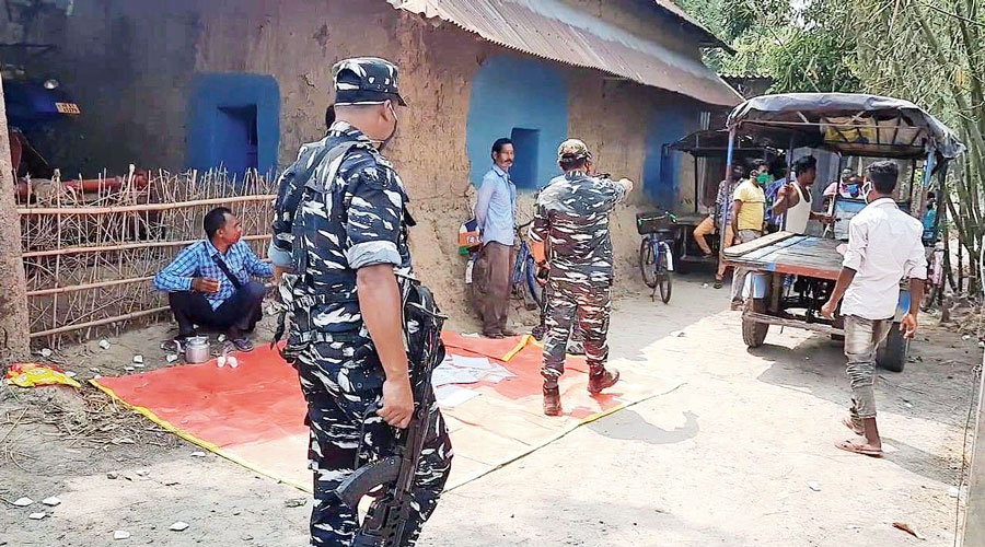 Paramilitary personnel patrol a village in South Dinajpur district during the voting on Monday.