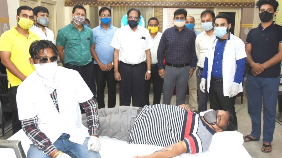 A volunteer donates blood at a camp set up by Marwari Yuva Manch office in Purana Bazar, Dhanbad, on Tuesday.
