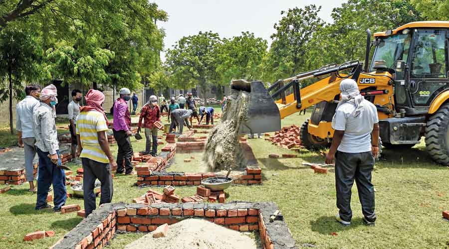 An excavator pours concrete in one of the chambers  built by the workers