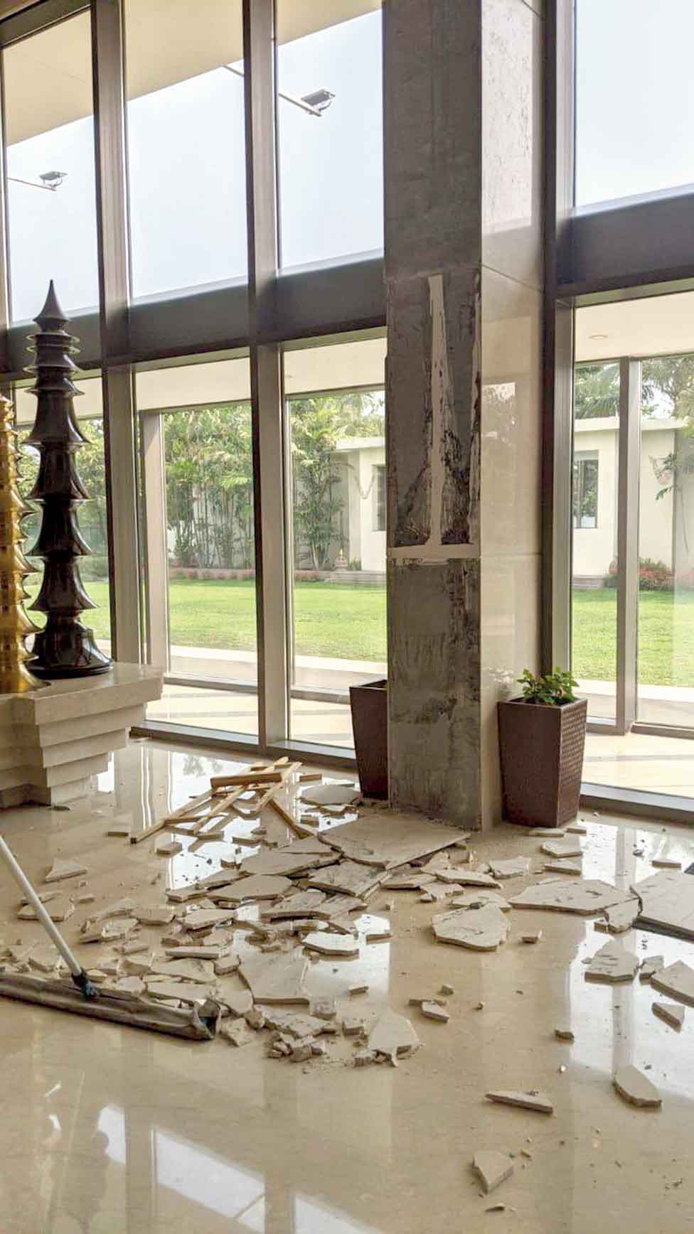 Broken tiles lie scattered in a building damaged in  the earthquake