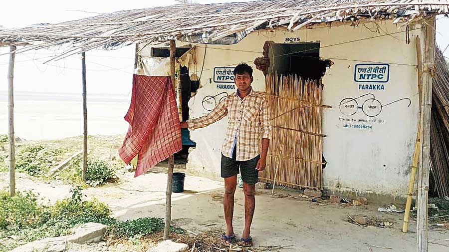 Jaydeb Mandal in front of the toilet that has been his home for two years at Baishnabnagar in Malda. 