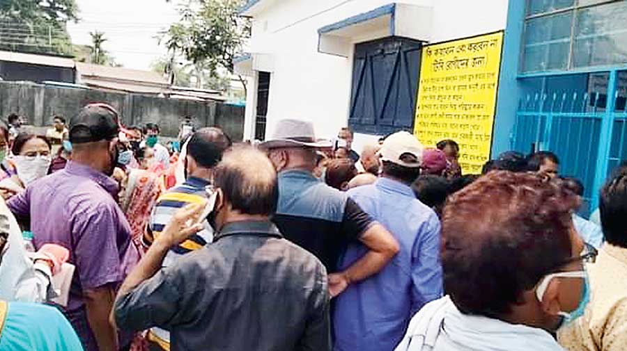 People stand in queue in front of a health centre to get a jab at Debidanga, on the outskirts of Siliguri, on Wednesday.  