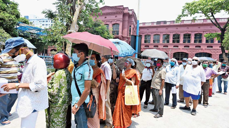 People wait at SSKM Hospital to get vaccinated on Wednesday.