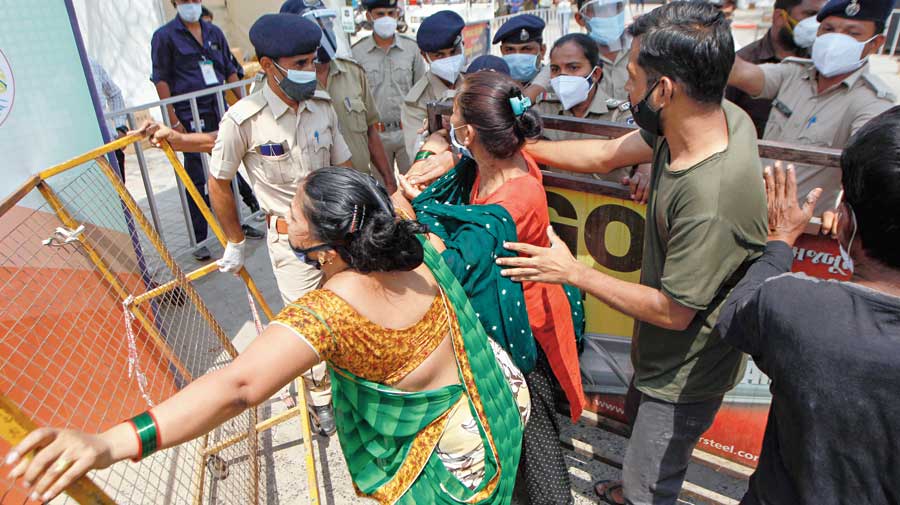 Relatives of a Covid patient breach barricades in an attempt to enter the Dhanvantri Covid-19 hospital in Ahmedabad for admission on Thursday. Gujarat High Court has  directed the state government to make sure each and every patient reaching a designated Covid hospital is attended to and given preliminary treatment even if beds are not available.  The bench expressed concern over government-run and designated Covid hospitals in Ahmedabad attending only to patients coming in the EMRI (Emergency Management and Research Institute)-run ‘108 ambulances’ and ignoring those brought in private vehicles.  “The state government and the Ahmedabad Municipal Corporation were aware that there is a shortage of 108 ambulances and if that was so, what justification can there be if patients reach the hospital in their privately arranged vehicles?” the court said. 