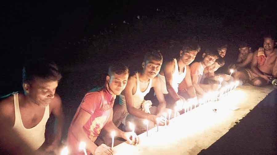 Youths of former enclave Mashaldanga in Cooch Behar light candles on Saturday night to celebrate the sixth anniversary of the merger with Indian mainland. 