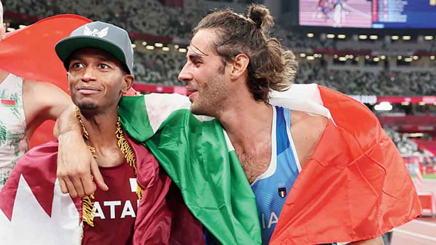 Mutaz Essa Barshim of Qatar (left) and Gianmarco Tamberi of Italy celebrate after jointly winning the gold. 