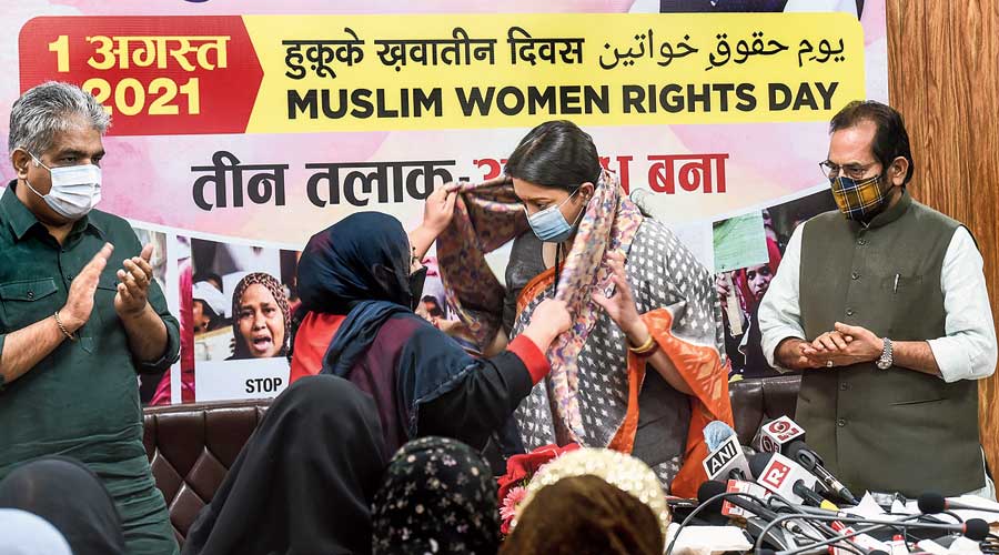 Union ministers Smriti Irani, Bhupinder Yadav (left) and Mukhtar Abbas Naqvi (right) in New Delhi  during the Muslim Women’s Rights  Day on Sunday. 