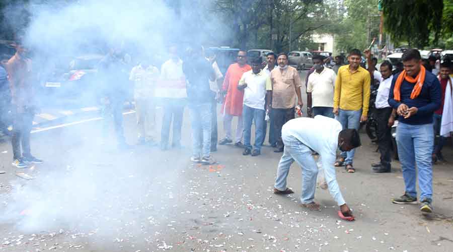 Members of the Dhanbad District Olympic Association burst crackers at Randhir Verma Chowk on Thursday.