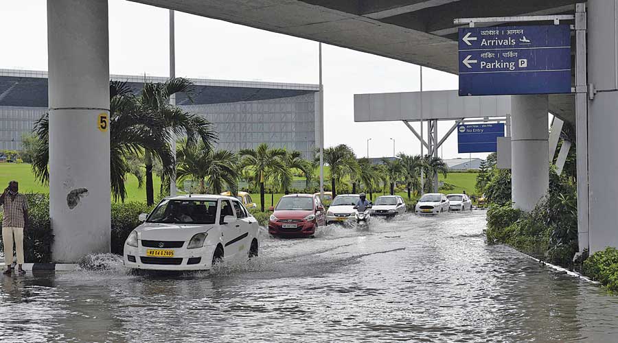 Vehicles on a flooded road in the airport compound