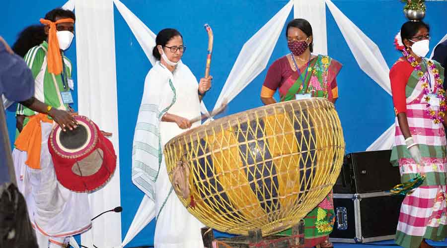 Mamata beats a drum during the World Tribal Day celebration in Jhargram on Monday.