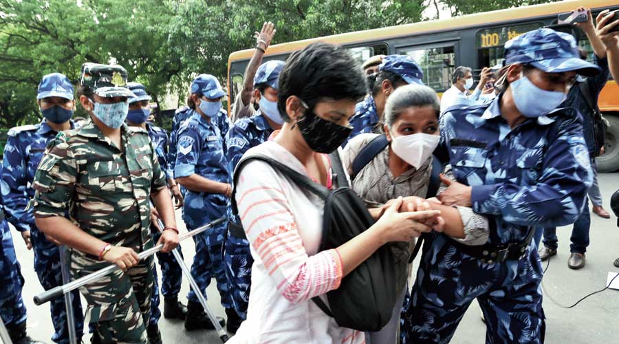 Police detain activists protesting against communal and hate speech in New Delhi on Tuesday.