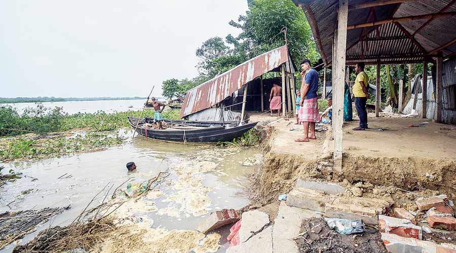 Residents in ward-16 of Santipur town, Nadia, on Wednesday survey the damage of Tuesday night’s erosion.