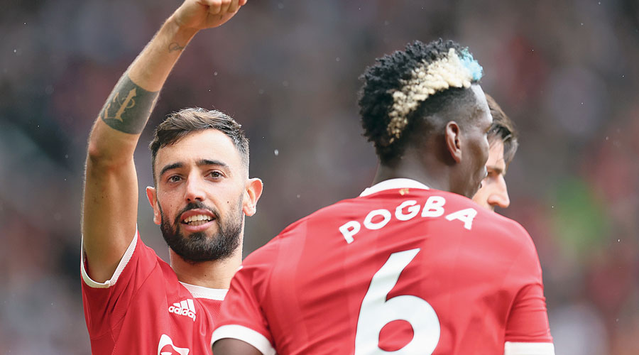 Bruno Fernandes (left) acknowledges Paul Pogba’s assist after he scored Manchester United’s third and his second goal against Leeds United during the Premier League match at Old Trafford on Saturday. 