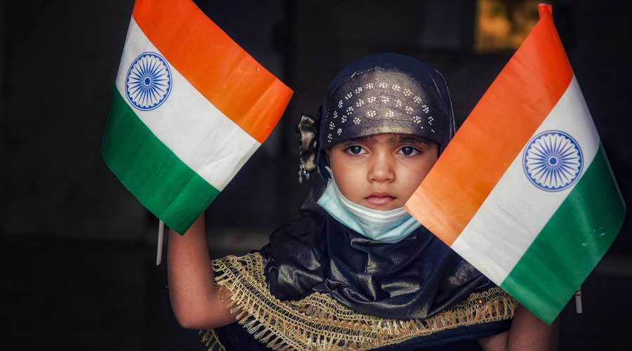 A child waves the national flags to celebrate the 75th Independence Day, in Ajmer