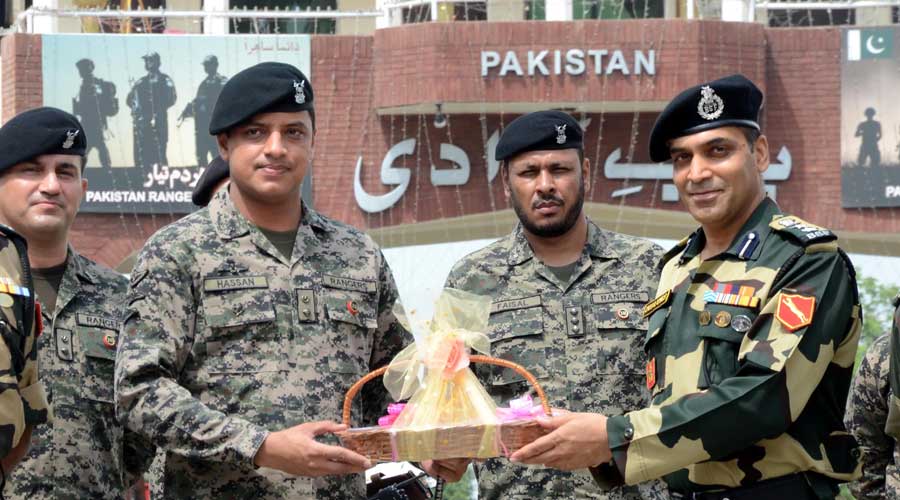  Border Security Force (BSF) Commandant Jasbir Singh presents sweets to Pakistani Wing Commander Hassan on occasion of Indias 75th Independence Day, at the India-Pakistan Attari-Wagah