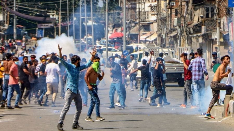 Police use tear gas on people carrying out Muharram procession in Srinagar on Tuesday.