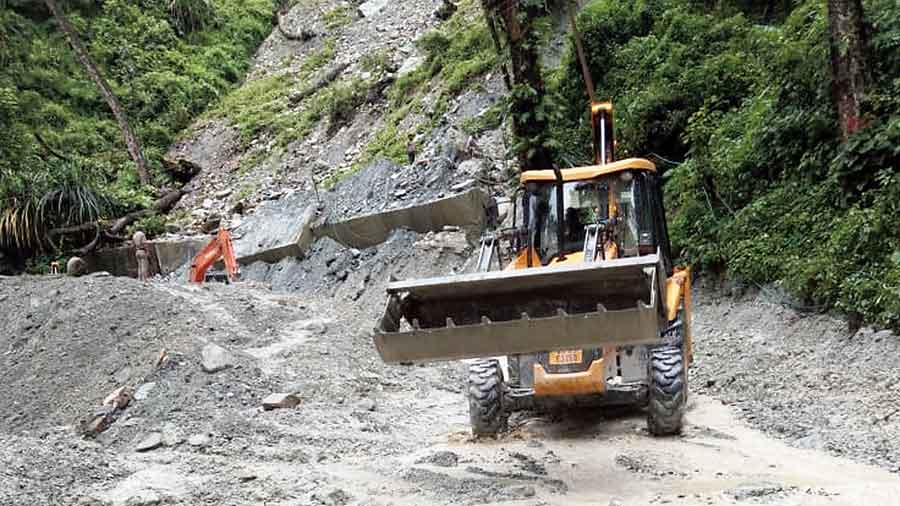 An excavator on the site of the landslide on NH10 on Thursday. 