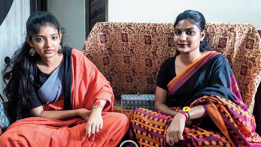 Rupa Biswas of Mahisbathan and Sangita Das of Duttabad display the rakhis they have made on their own wrists.