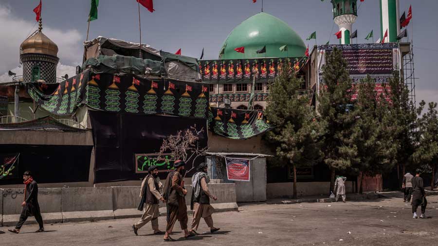 Members of the Taliban, center, look to secure a site for an Ashura celebration in Kabul, Afghanistan on Thursday, Aug. 19, 2021.