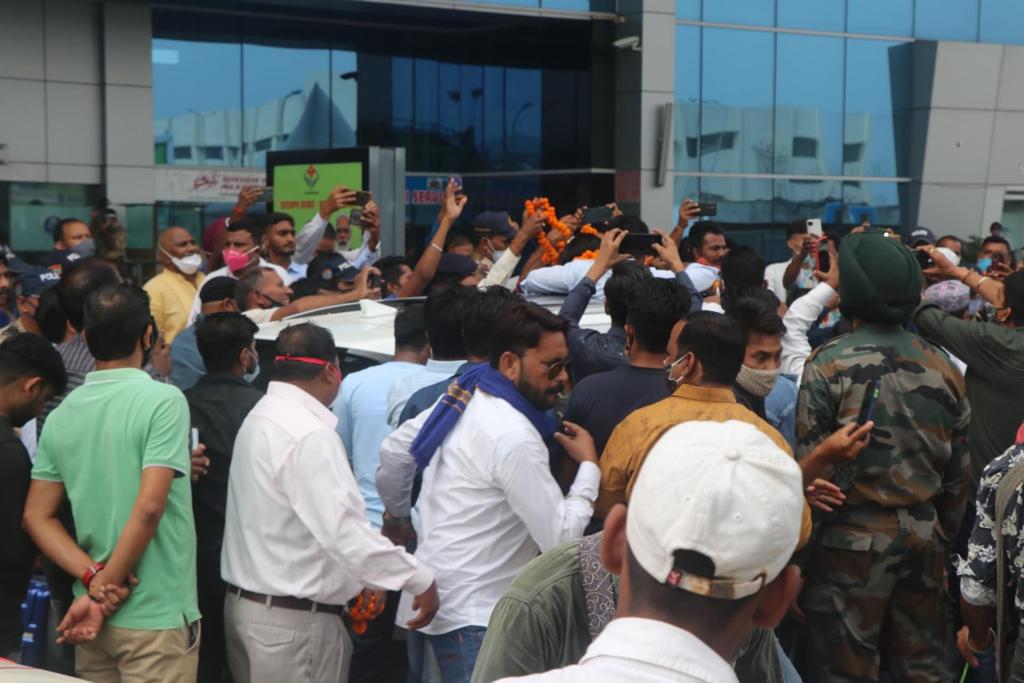 The crowd around Vandana's car at Dehradun Airport.