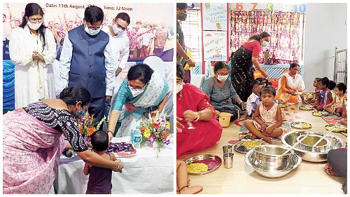 Children at lunchtime. Minister Chandrima Bhattacharya hands a chocolate to a child at the inauguration.