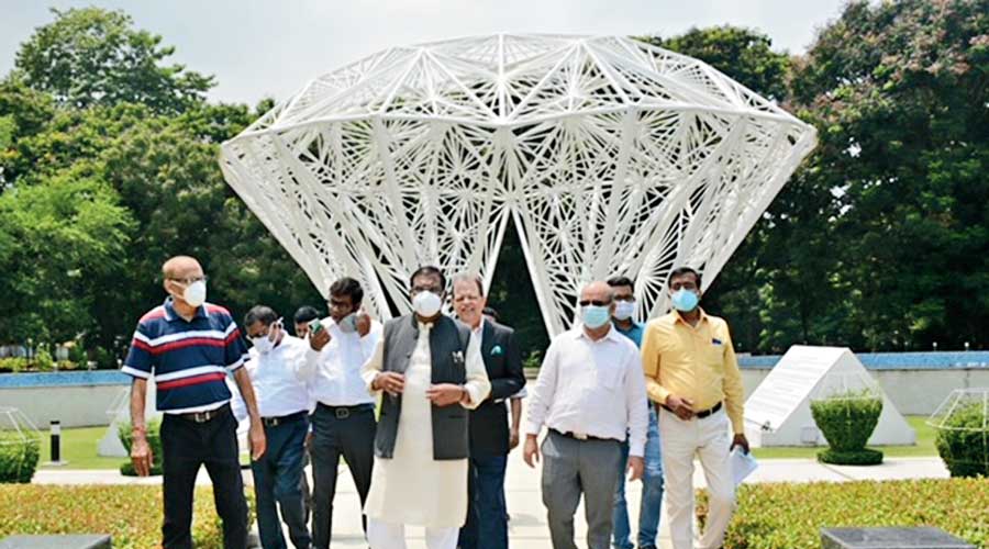 Faggan Singh Kulaste (centre in white mask) along with Tata Steel officials at the Dorabji Tata Park in Jamshedpur on Friday