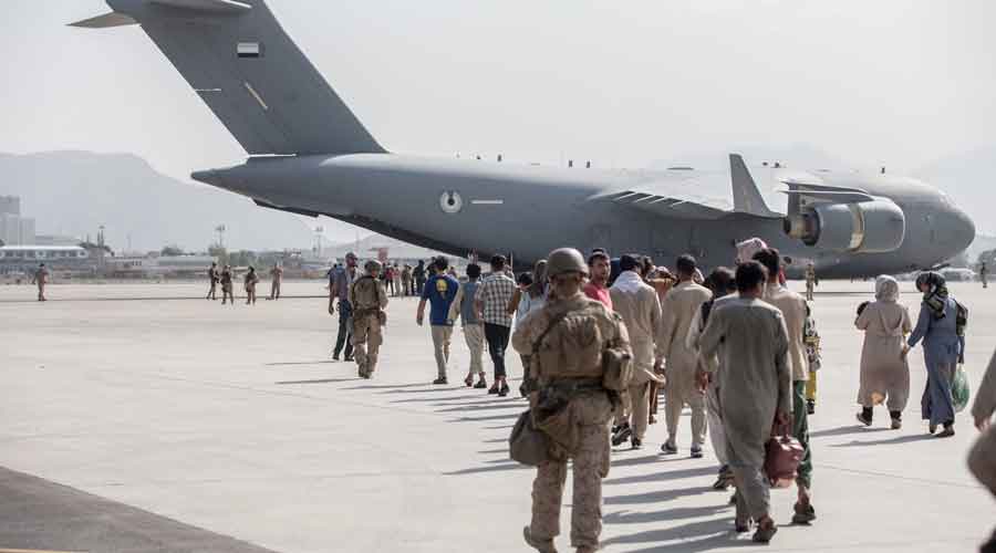 Afghan civilians board C-17 Globemasters at Hamid Karzai International Airport in Kabul.