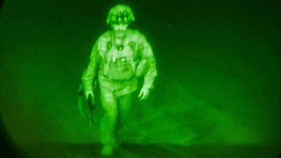 U.S. Army Major General Chris Donahue, commander of the 82nd Airborne Division, steps on board a transport plane as what the XVIII Airborne Corps calls the last Soldier to leave Kabul on Monday in a photograph using night vision optics.